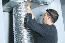 Man working on air duct